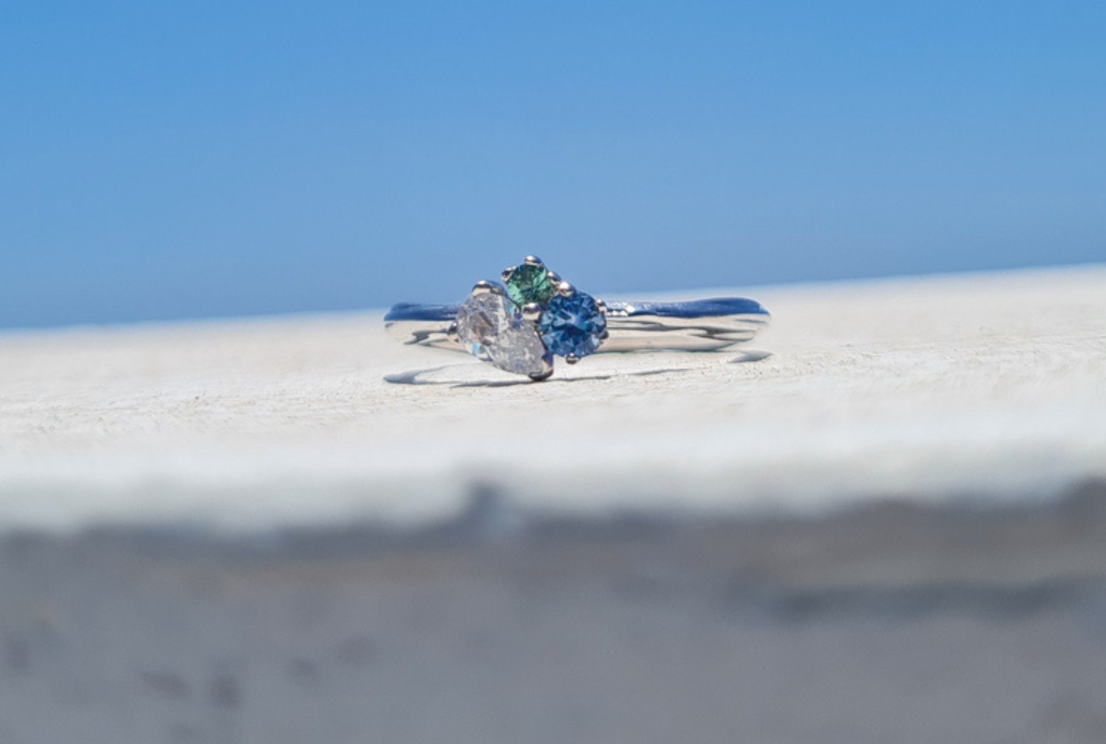 3 stone cluster engagement ring blue sapphire seafoam green tourmaline and pear diamond