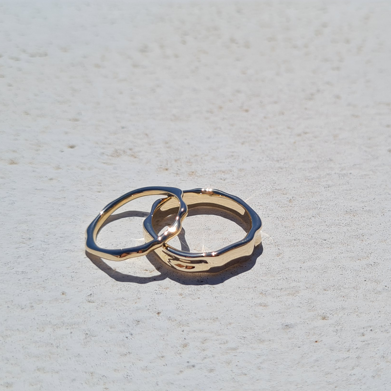 Ripple shimmering water inspired texture wedding rings alternative rings for both men and women by fine jewellery designer Emma Hedley in recycled yellow gold