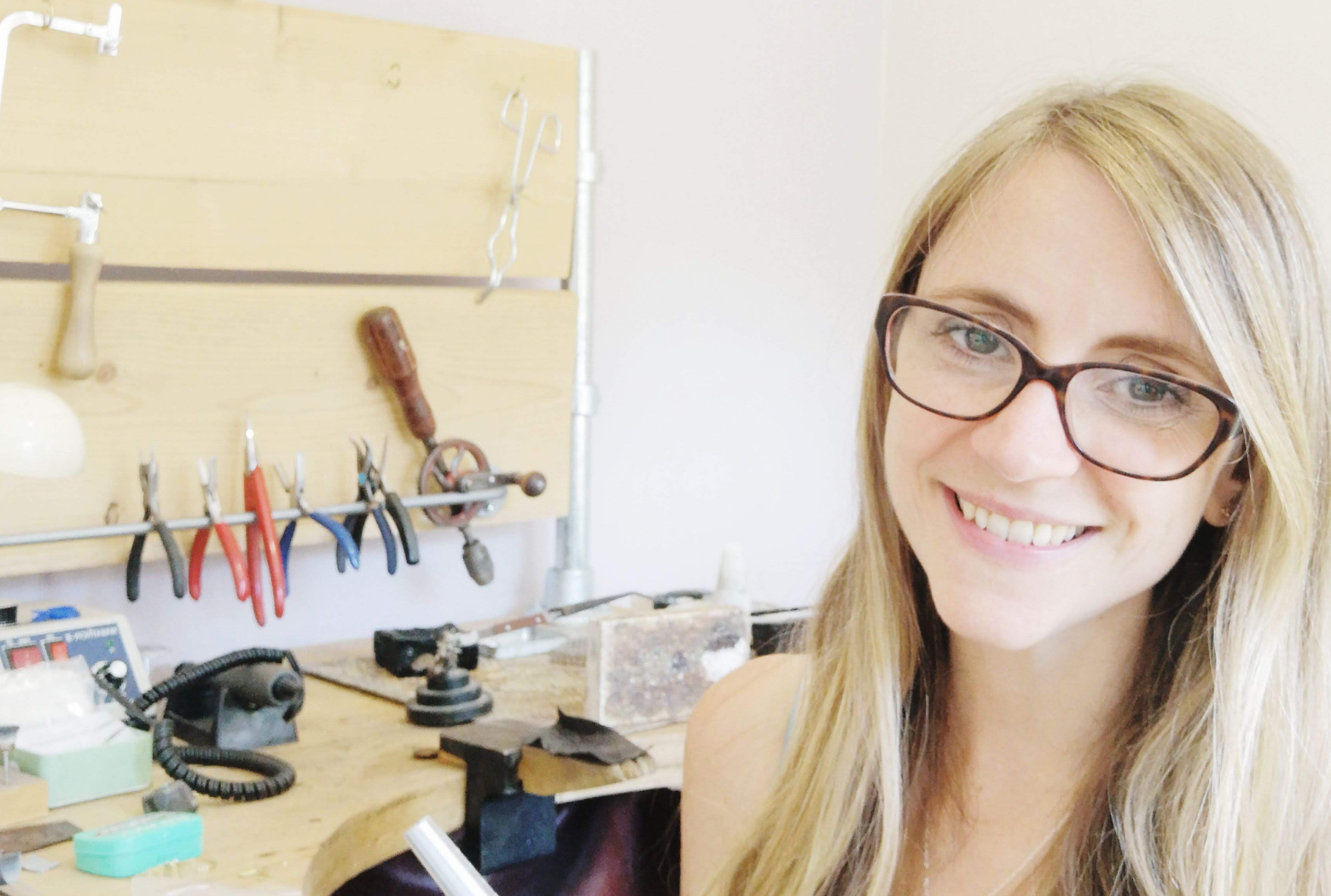 Emma Hedley Sitting at her jewellers bench smiling