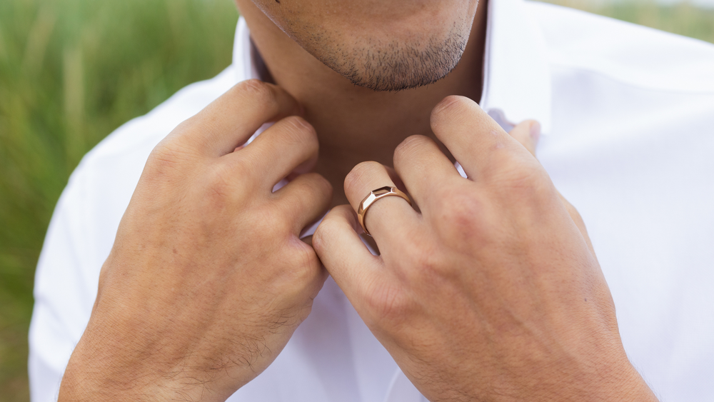 Gents 5mm recycled yellow gold Faceted texture wedding ring Facets worn on  a man's hand by Emma Hedley- photography by Claire Collinson