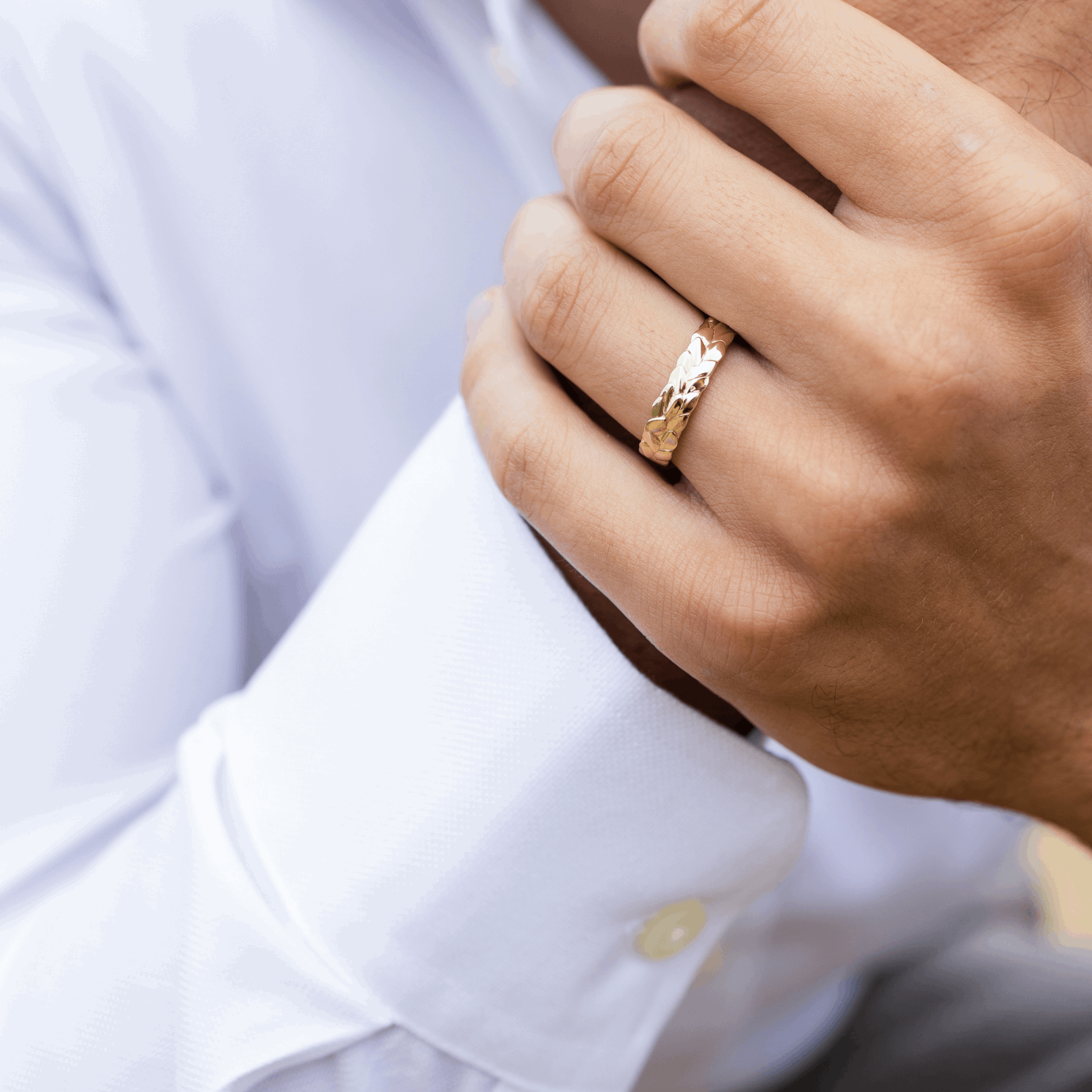 5mm recycled yellow gold leaf detail yellow gold textured unique wedding ring on a gent's hand Fine jewellery Designer Emma Hedley Claire Collinson Photography