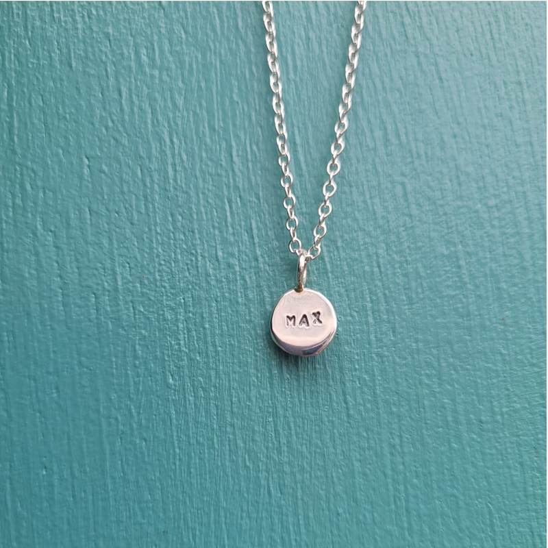 Silver coin disk pendant with the name Max hand stamped on an 18" chain