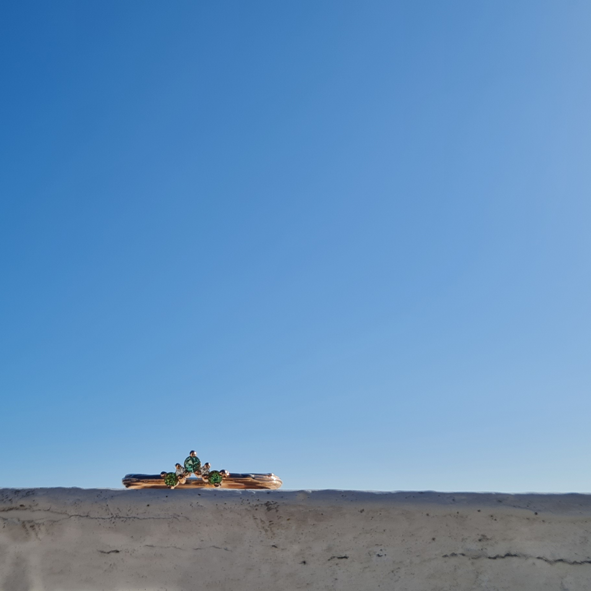 Organic Caress 9ct rose gold shaped wedding engagement ring with green blue seafoam tourmaline and natural Canada Mark diamonds against a vibrant blue sky unique different individual alternative colourful gemstone  jewellery by Emma Hedley Newcastle Upon Tyne