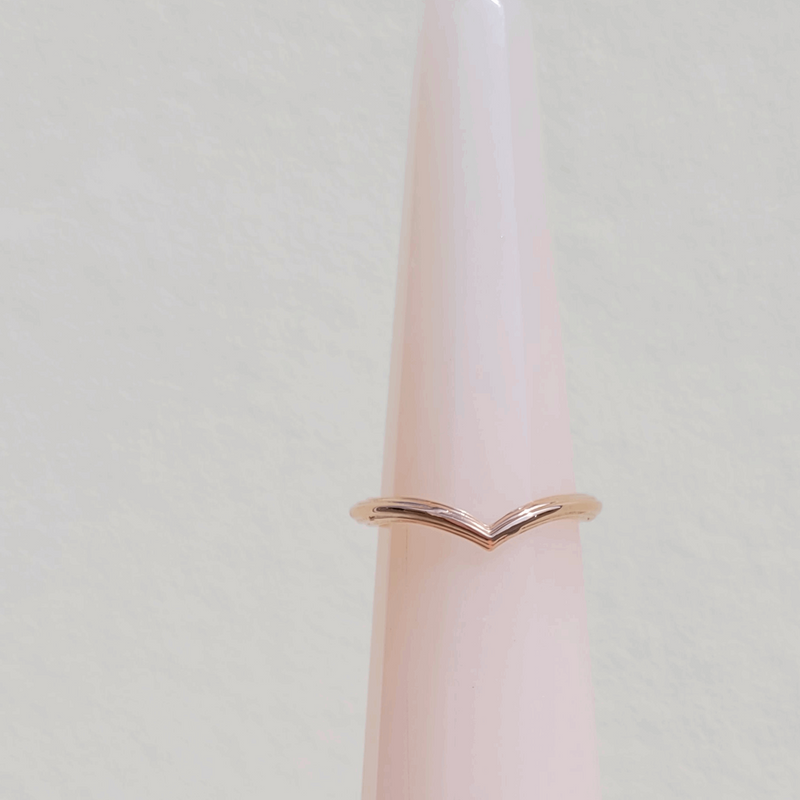 9ct recycled Rose gold Organic textured wishbone wedding ring displayed on a ring cone by Emma Hedley ethically made unique alternative fine jewellery nature inspired whimsical unique rings