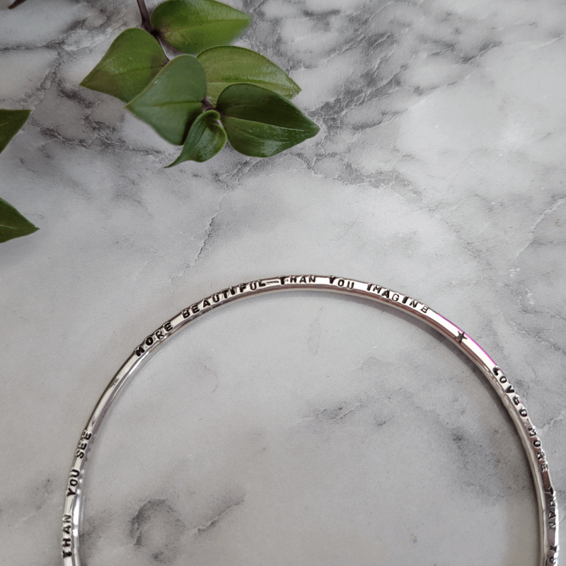 Custom Personalised Lyric Bangle with hand stamped message handmade from sterling silver by Emma Hedley Jewellery Designer