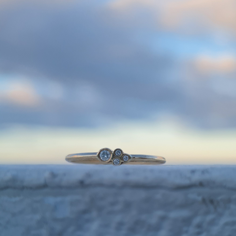 Petite cluster engagement ring under £1000 set with ethically sourced lab grown Diamonds set in 9ct recycled yellow gold Emma Hedley fine Jewellery budget friendly dainty promise ring with round bezel setting for extra comfort understated elegance