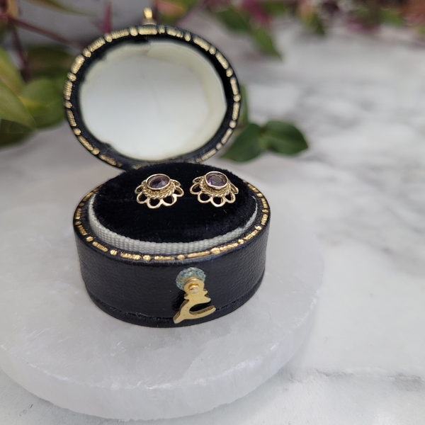 February birthstone Vintage 9ct yellow gold amethyst flower stud earrings side view twisted rope detail bezel set rub over setting in small black and gold vintage leather oval box