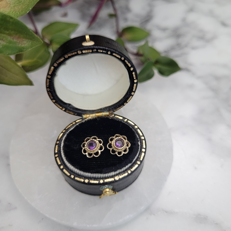 Vintage 9ct yellow gold amethyst flower stud earrings February birthstone stacking studs earrings rub over bezel setting top view in small oval vintage leather box
