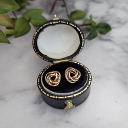 Vintage 9ct yellow gold knot stud earrings  displayed in a black and gold oval vintage leather box 